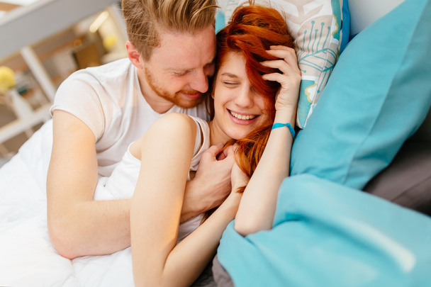 Romantic couple in love lying on bed - Photo, Image