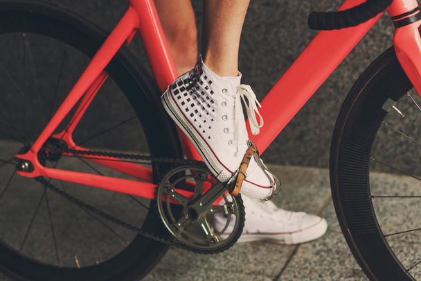 Young woman foot at bicycle pedal closeup - 写真・画像