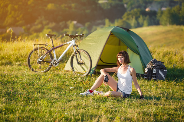 Reizen met fiets alleen - jonge vrouw in de tent - Foto, afbeelding