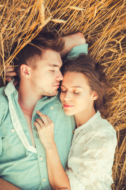 Young couple in love outdoor.Stunning sensual outdoor portrait of young stylish fashion couple posing in summer in  field - Fotó, kép