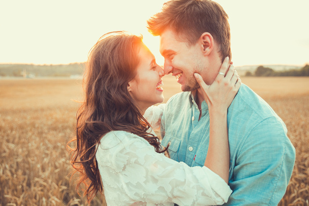 Young couple in love outdoor.Stunning sensual outdoor portrait of young stylish fashion couple posing in summer in  field - Photo, image
