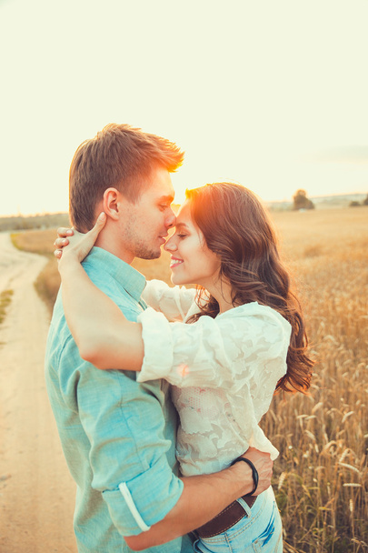 Young couple in love outdoor.Stunning sensual outdoor portrait of young stylish fashion couple posing in summer in  field - Zdjęcie, obraz