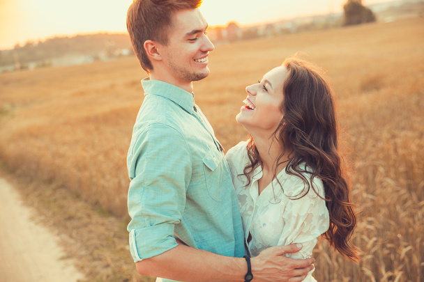 Young couple in love outdoor.Stunning sensual outdoor portrait of young stylish fashion couple posing in summer in  field - Foto, immagini
