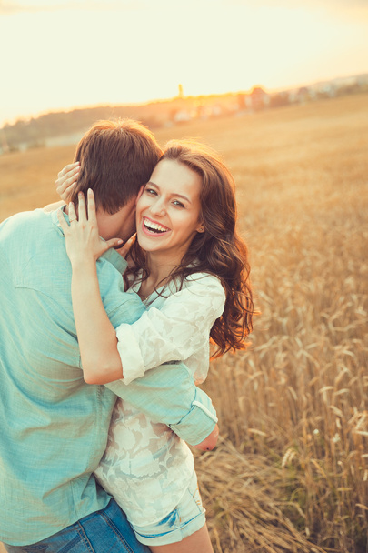 Young couple in love outdoor.Stunning sensual outdoor portrait of young stylish fashion couple posing in summer in  field - Foto, imagen