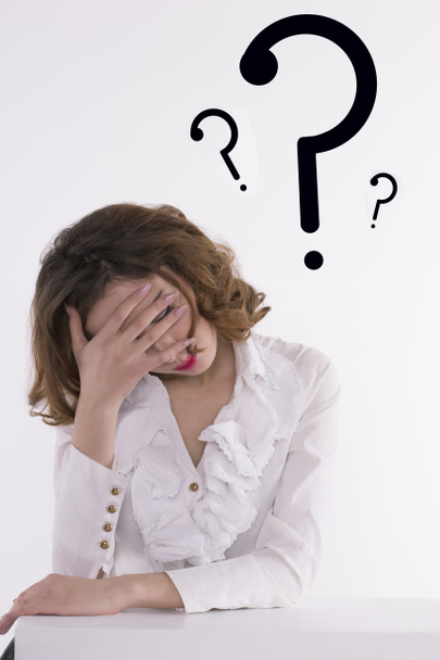 Tired woman thinking with question mark near head - Photo, Image