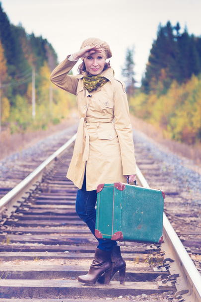 Elegant woman with a suitcase traveling by rail. - Foto, imagen