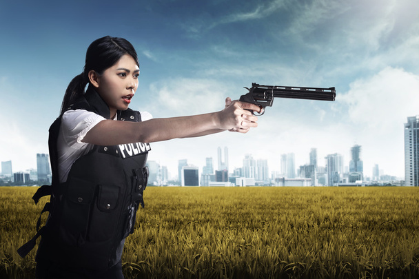 Beautiful police woman holding gun - Fotografie, Obrázek