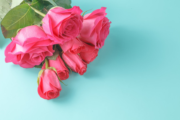Image of roses on aquamarine background - Фото, изображение