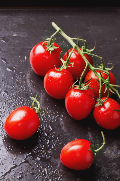 Organic Ripe Tomatoes on black background - Photo, Image