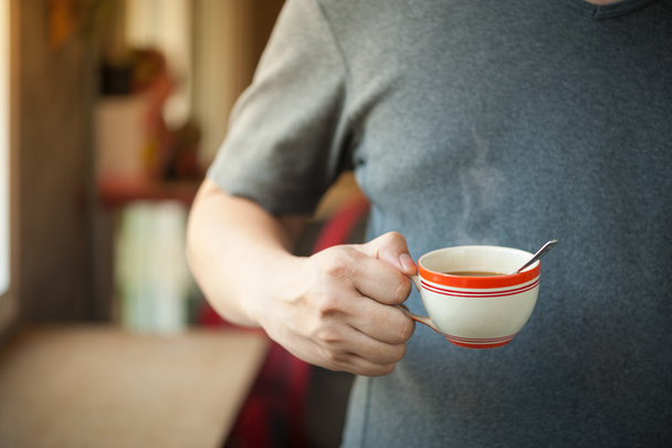 Кофейная чашка в руке мужчины
 - Фото, изображение