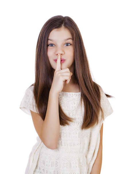 Little girl has put forefinger to lips as sign of silence - Photo, Image