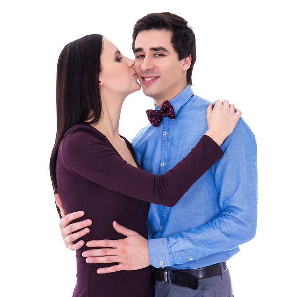 portrait of happy young woman kissing her husband isolated on wh - Foto, immagini