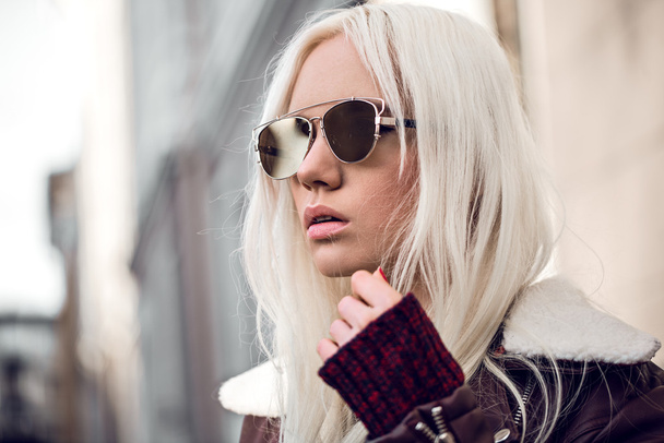 Cute  blonde girl wearing in sunglassses outside - Fotó, kép