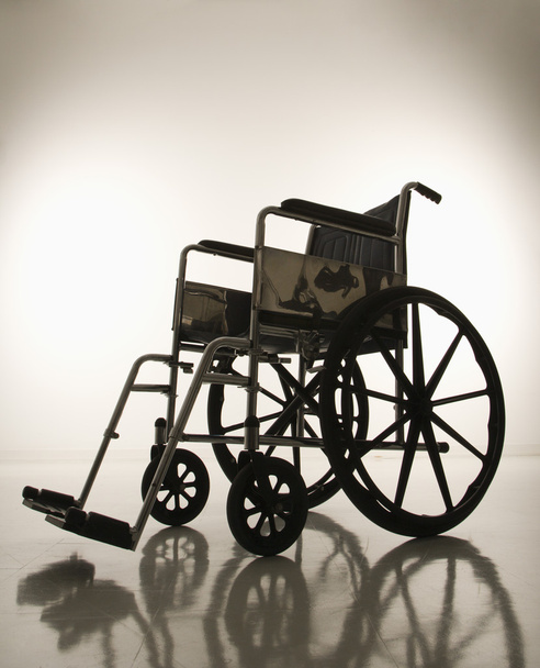Empty silhouetted wheelchair. - 写真・画像