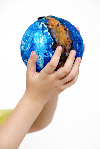 Children's hands holding globe made the child - Фото, изображение