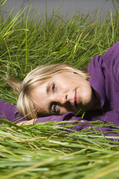 Woman lying in grass. - Φωτογραφία, εικόνα