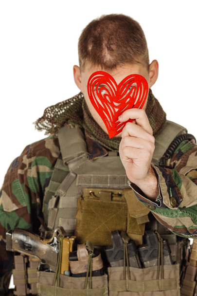 young soldier holding red heart in his hands - Φωτογραφία, εικόνα