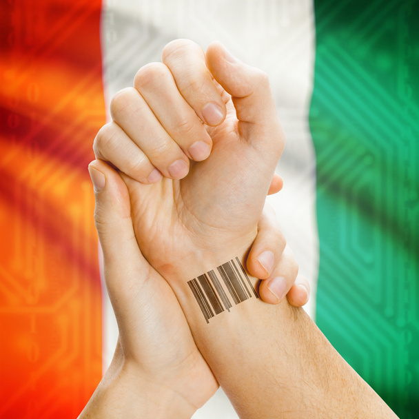 Barcode ID number on wrist and national flag on background series - Ivory Coast - Foto, Imagen