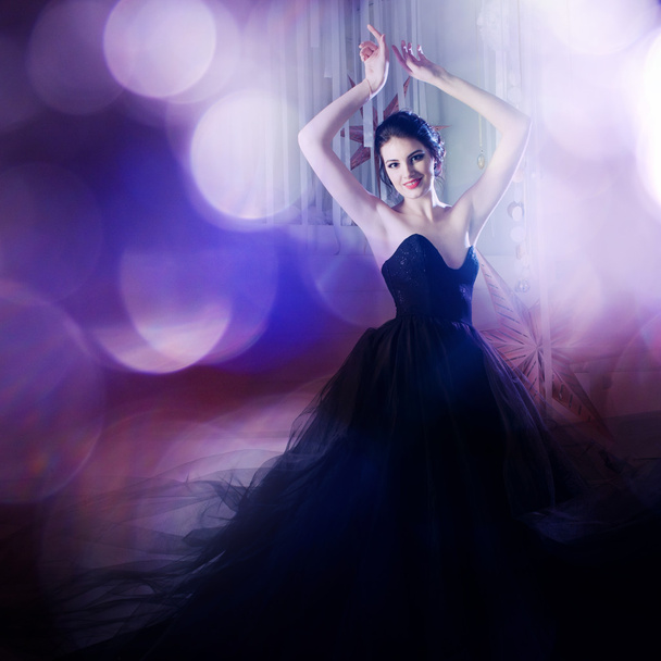 Beauty Brunette model woman holiday make up. Elegant girl in a black dress with very long train - Zdjęcie, obraz