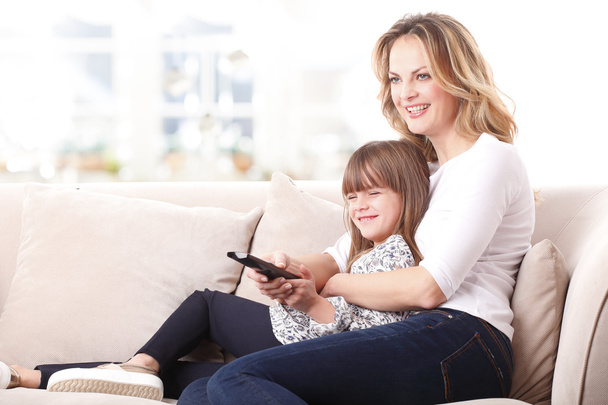 mother and daughter watching tv - Photo, image