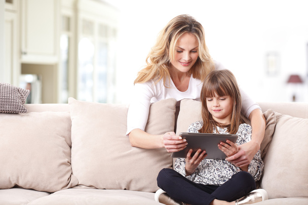 mother and daughter using  tablet. - Valokuva, kuva