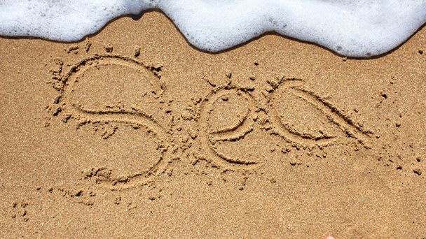 Sea word written on beach sand. - Φωτογραφία, εικόνα