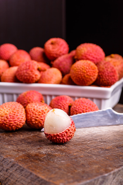 Lychee fruit, which is called Chinese plum, is on the dark Board - Φωτογραφία, εικόνα