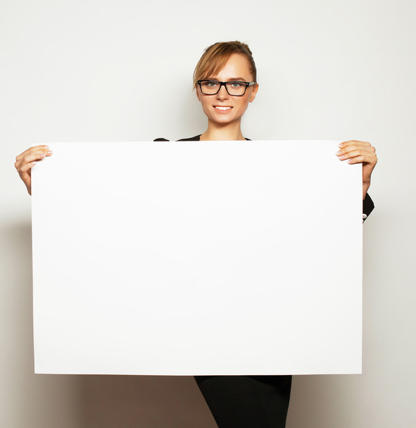 business woman holding a blank billboard. - 写真・画像