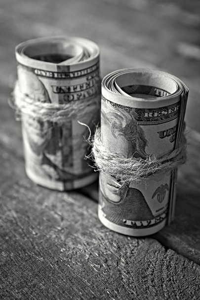 Dollars rolls on wooden table - Photo, Image