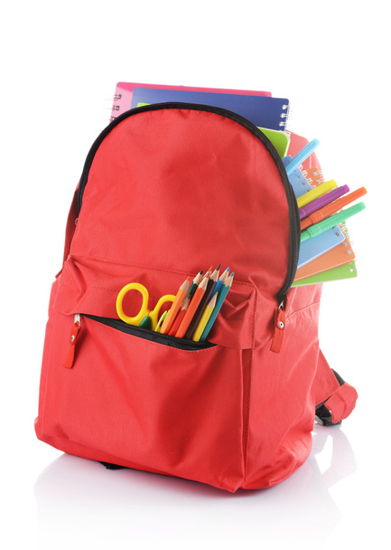Red backpack with colourful stationary  - Fotó, kép