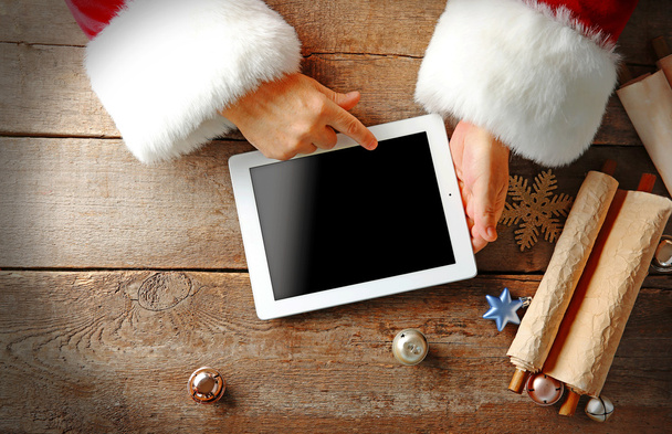 Santa with tablet in hands - Фото, изображение