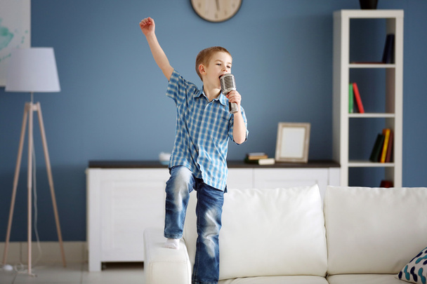 Little boy singing into microphone  - Фото, изображение