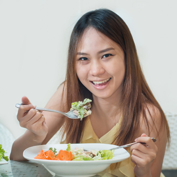 Close-up Of Beautiful Asia Woman suntan skin Eating Salad At Hom - Photo, Image