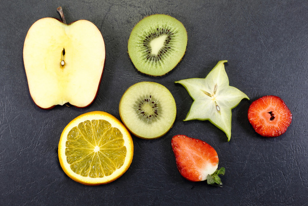 Yellow green kiwi apple orange strawberry slice - Photo, Image