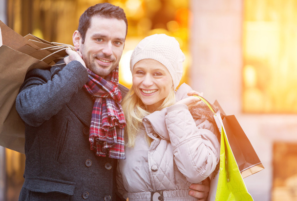 Young attractive couple with shopping bags - Foto, Imagem