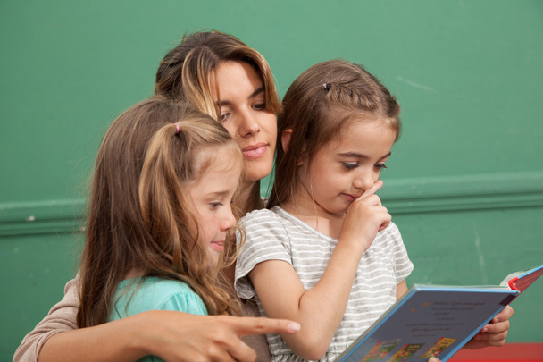 girls reading a book - Фото, изображение