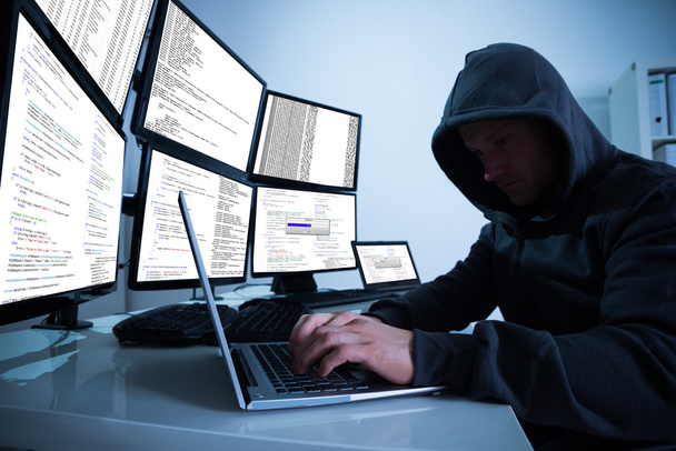 Hacker Using Laptop At Desk - Zdjęcie, obraz