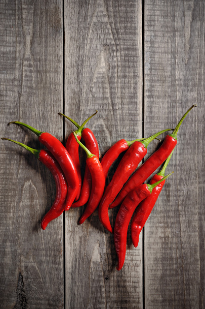 red hot chilly pepper spice on a wooden background - Fotoğraf, Görsel