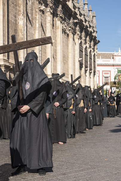 Penitent with his cross, Holy Week in Seville Nazarene Brotherhood of students - Photo, Image