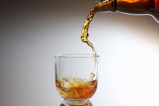 Whiskey being poured into a glass - Foto, Imagen