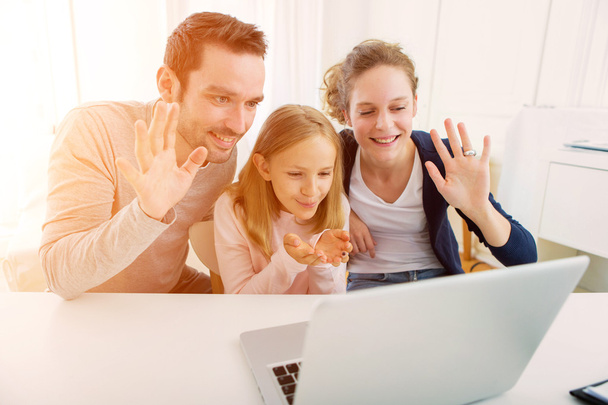 Family having a videocall on a laptop - Фото, зображення