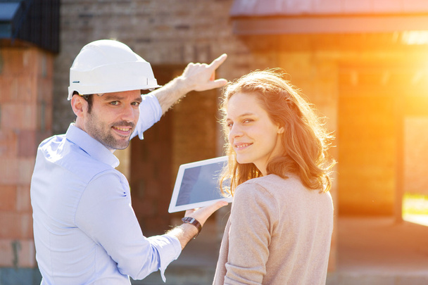 Young woman and architect on construction site  - Photo, Image