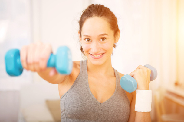 Young attractive girl doing exercise at home  - Foto, imagen