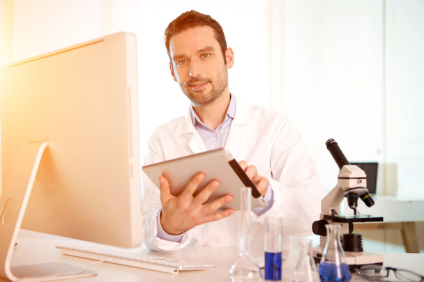 Young attractive man working in a laboratory - Φωτογραφία, εικόνα