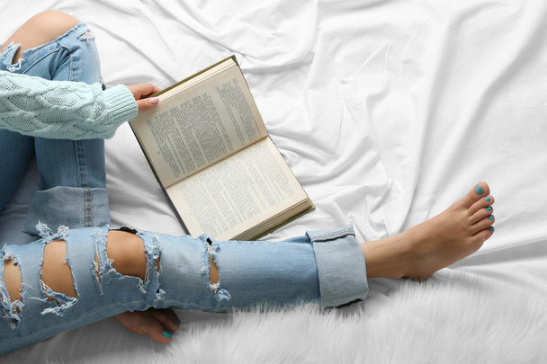 Woman in jeans on bed  - Foto, Imagem