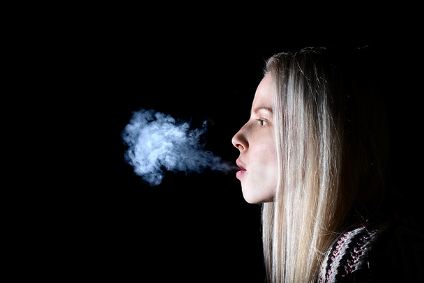 Woman Smoking a Cigarette - Valokuva, kuva
