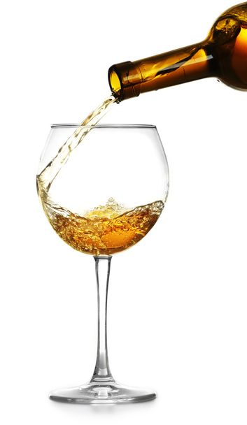 White wine pouring in glass, isolated on white - Фото, изображение