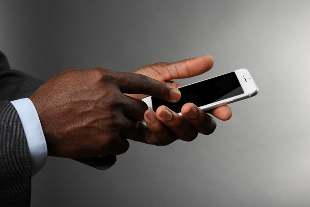 Afro american man holding smartphone  - Fotografie, Obrázek