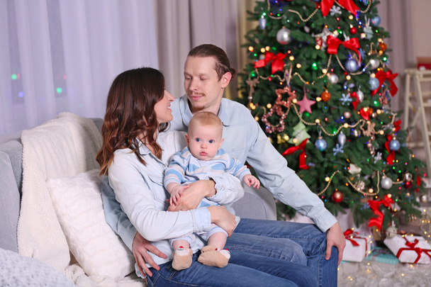 Happy family on sofa in Christmas room - Fotoğraf, Görsel