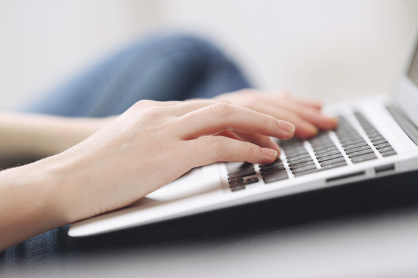 Woman sitting on sofa with laptop  - Foto, Imagen
